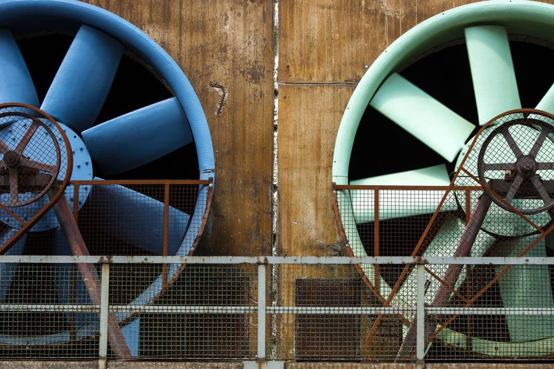 Large industrial ventilation fans on the end wall of a farm building